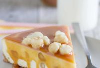 Creamy White Chocolate Cheesecake with Caramel Drizzle and Macadamia Crunch