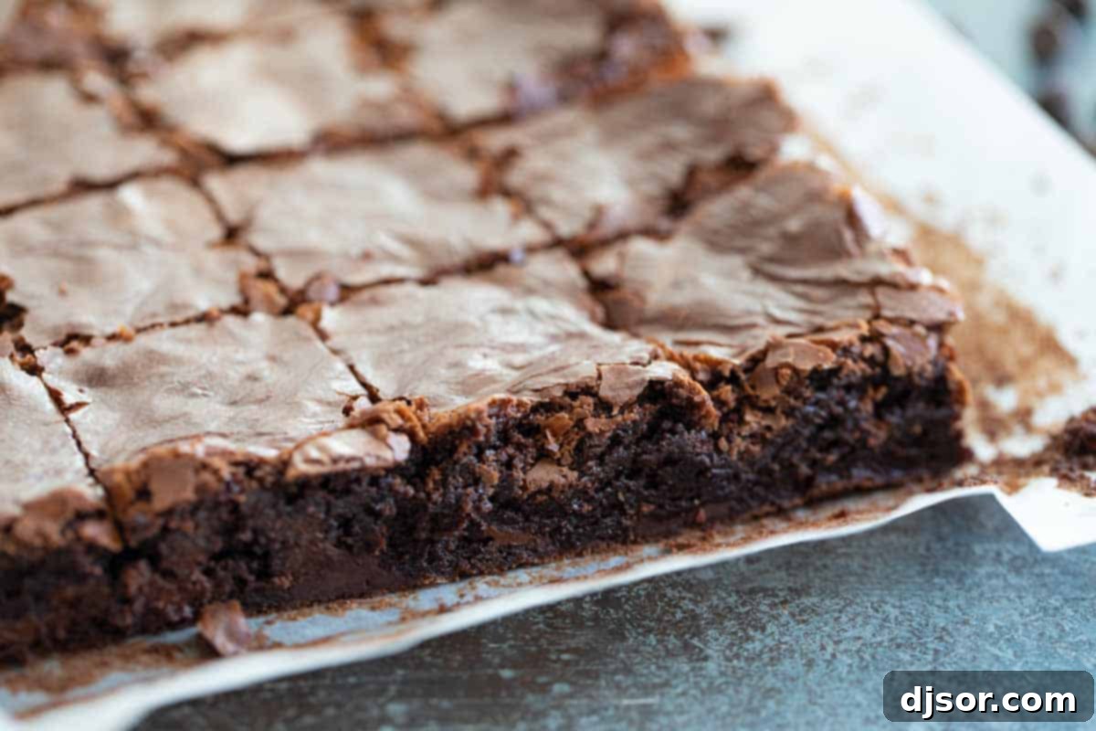 homemade brownies on parchment paper cut into squares