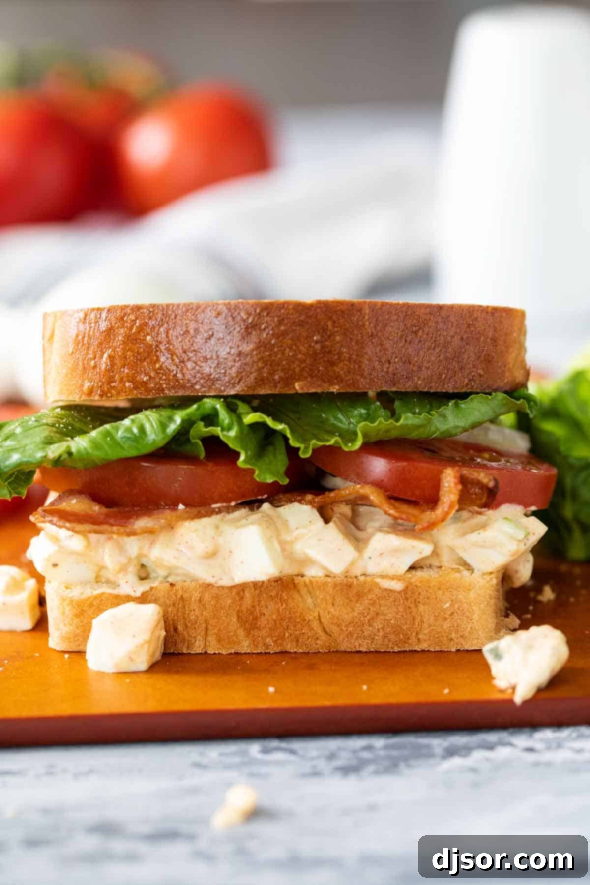 Easy Egg Salad BLT on a cutting board, showcasing the delicious layers.