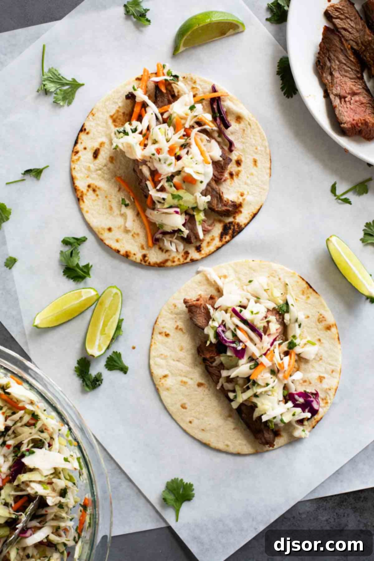 Siam Street Tacos 7 Two beautifully assembled Thai Tacos featuring marinated flank steak, fresh cilantro lime slaw, and a sprinkle of fresh cilantro.