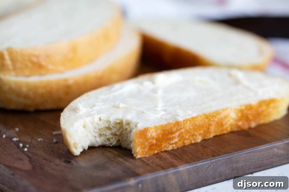 slice of peasant bread with a bite taken from it, showing the soft interior