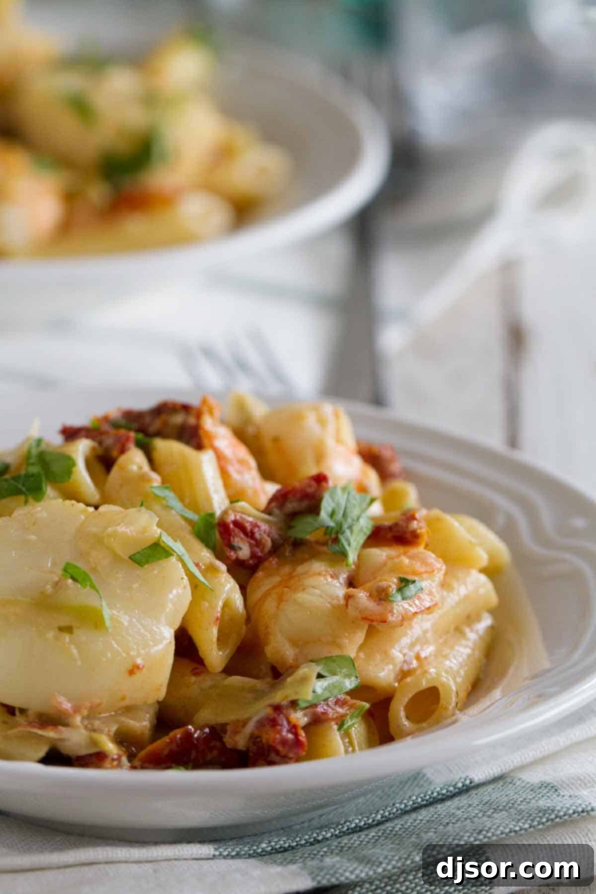 Serving Key West Penne: Seafood Pasta Garnished with Parsley A plate of Key West Penne, garnished with fresh herbs, ready to be enjoyed.