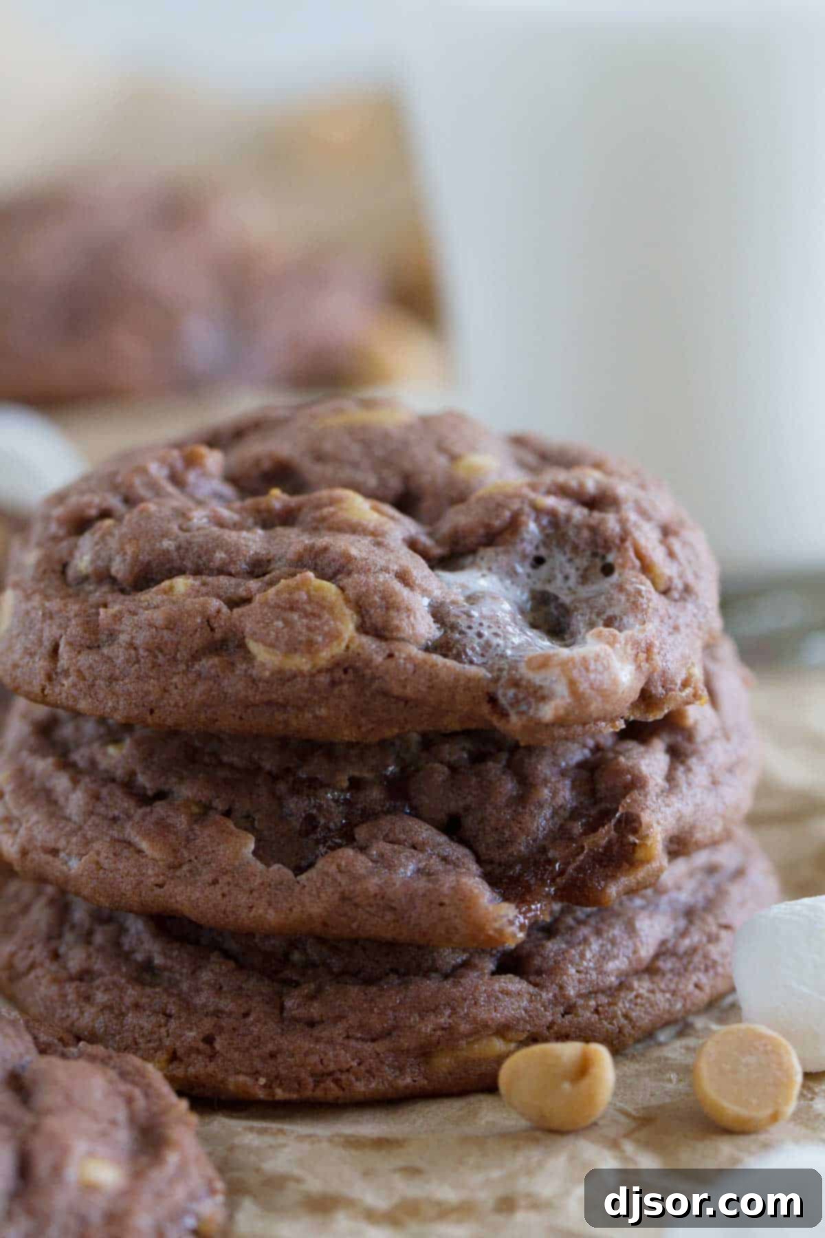 Stack of Chocolate, Peanut Butter, and Marshmallow Pudding Cookies, showcasing their gooey interior.