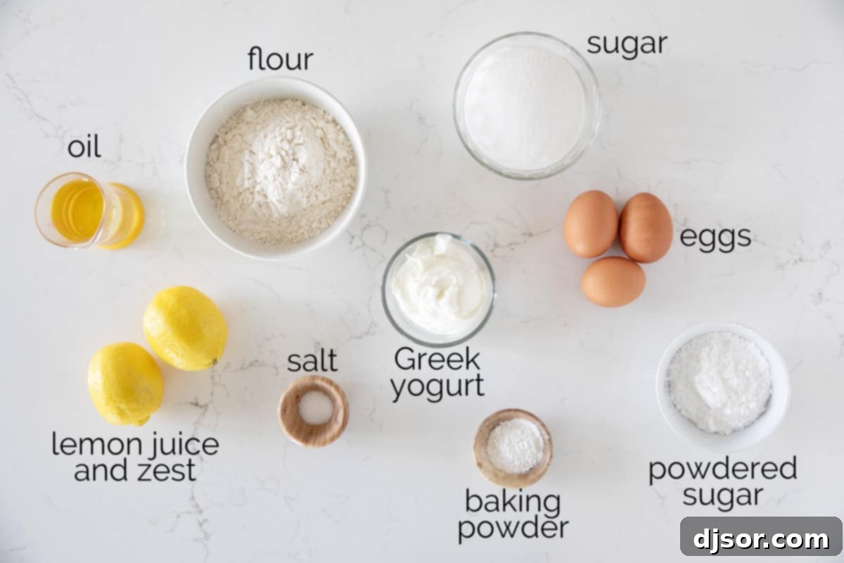 A collection of fresh ingredients laid out on a kitchen counter, including granulated sugar, a bowl of Greek yogurt, cooking oil, eggs, lemons, all-purpose flour, baking powder, salt, and powdered sugar, ready for making a Lemon Yogurt Cake.