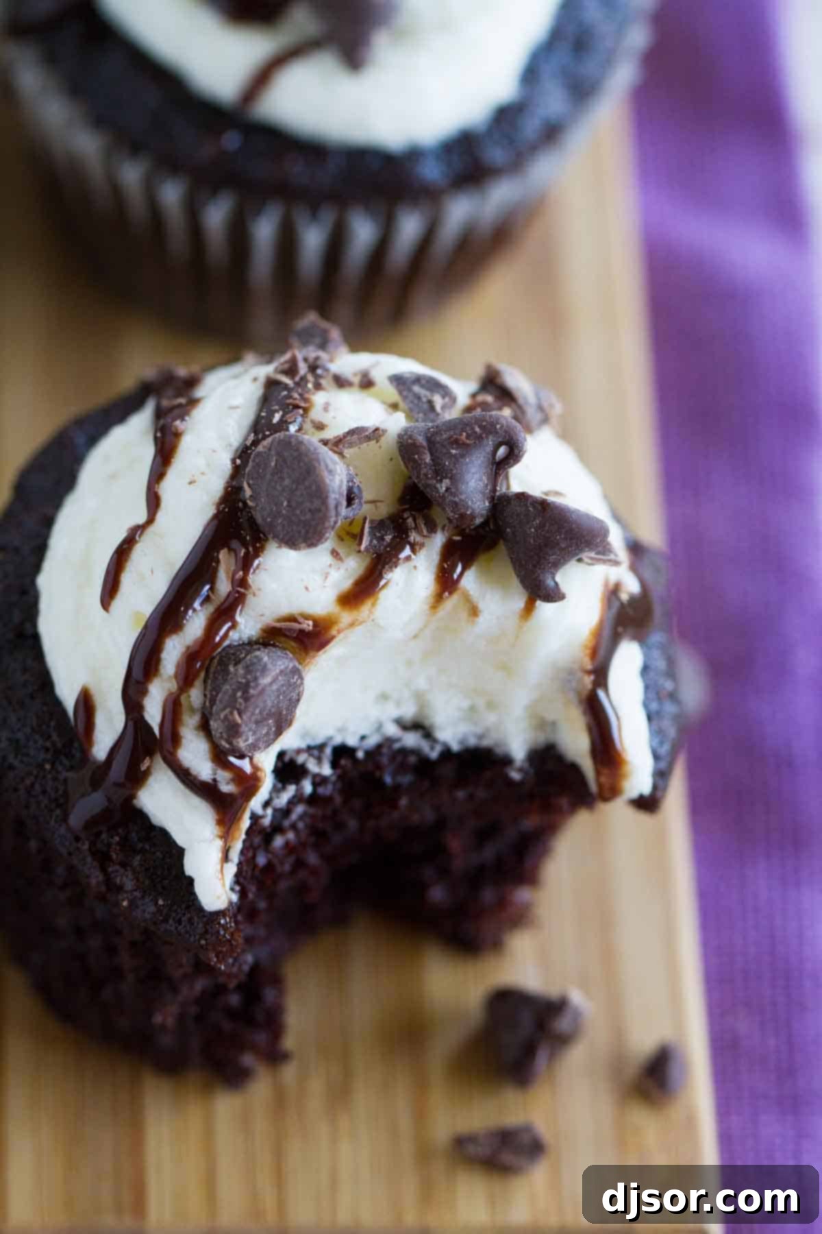 Decadent Chocolate Amaretto Cupcakes 3 Close-up shot of the rich texture of a Chocolate Amaretto Cupcake, showcasing the fluffy chocolate cake and smooth almond frosting