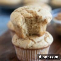 Irresistible Peanut Butter Muffins 10 Two peanut butter muffins stacked, with a bite taken from the top muffin.