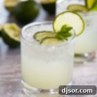 Cucumber Lime Chill 8 Glass of cucumber limeade with a lime slice on the glass.