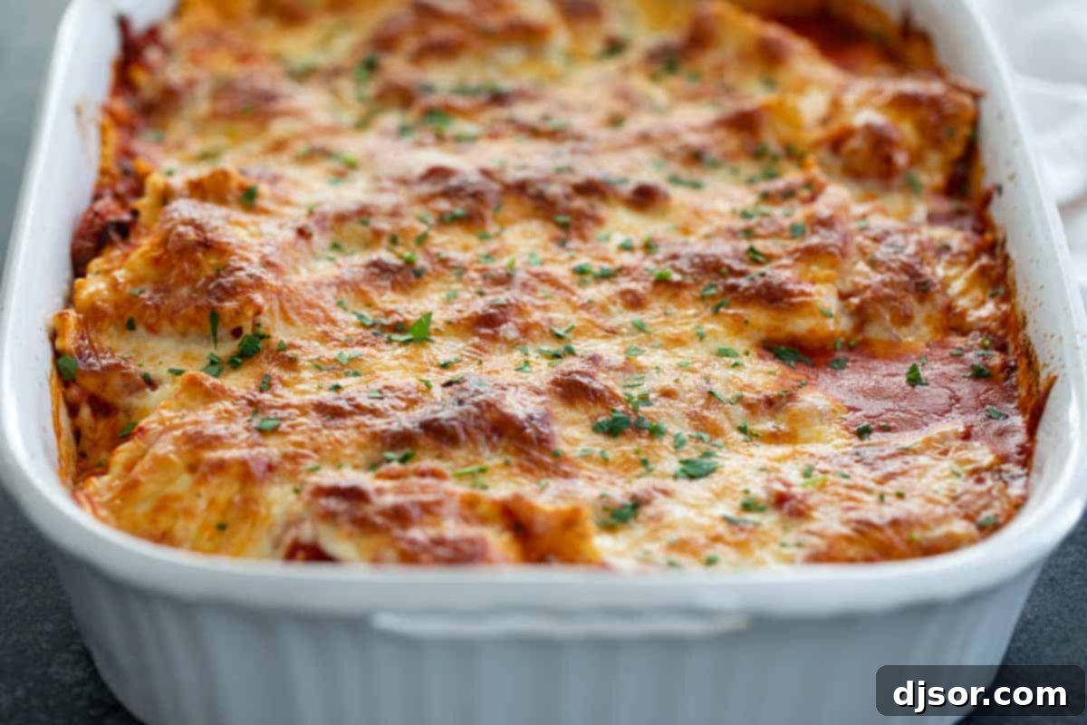 This Easy Baked Ravioli recipe takes frozen ravioli and combines it with a homemade pasta sauce and lots of cheese. It’s super easy and super filling! Dish of Cheesy Baked Ravioli with Homemade Sauce