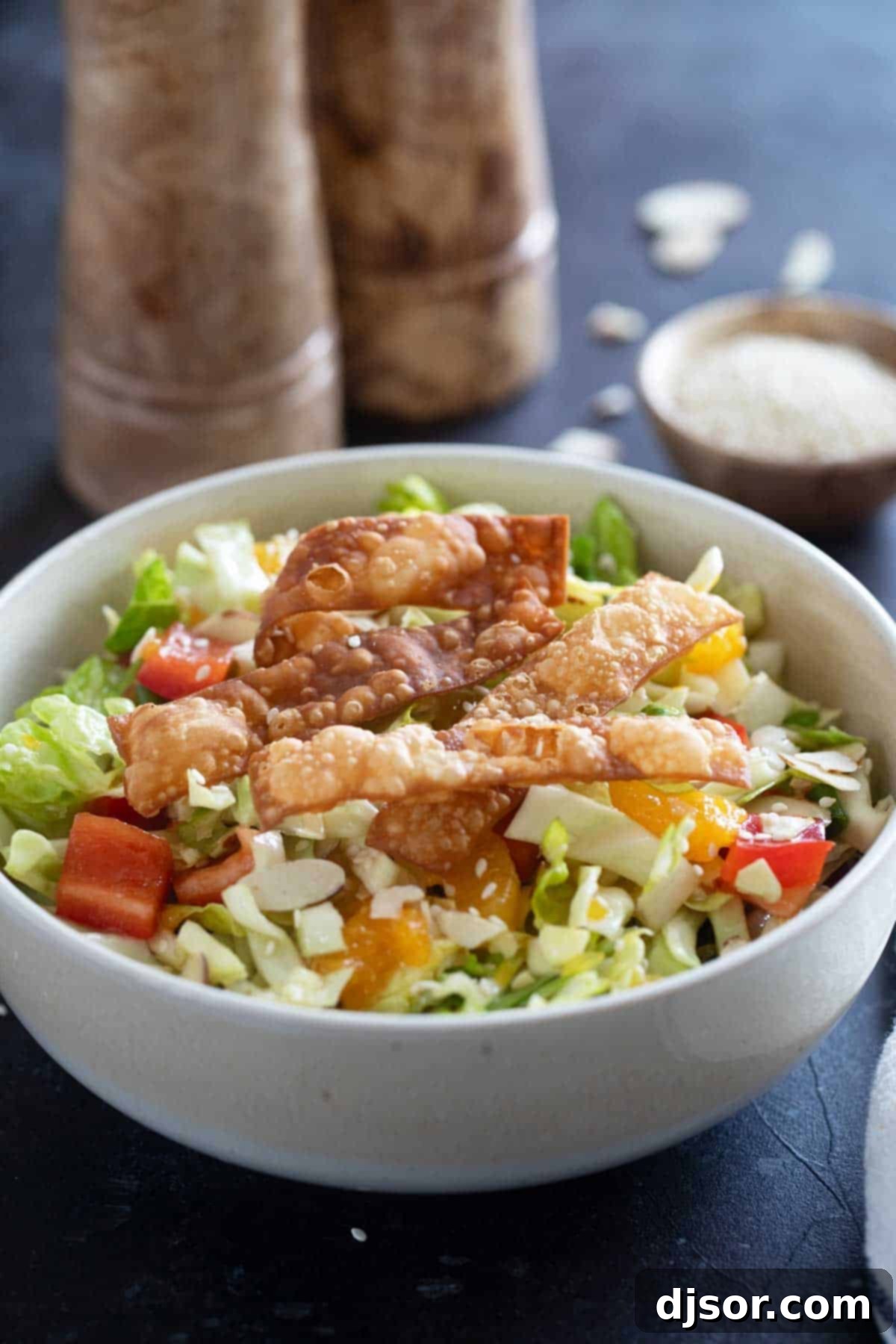 Vibrant Asian Crunch Salad 7 Asian Chopped Salad with cabbage, romaine, bell peppers, oranges, and wonton strips.