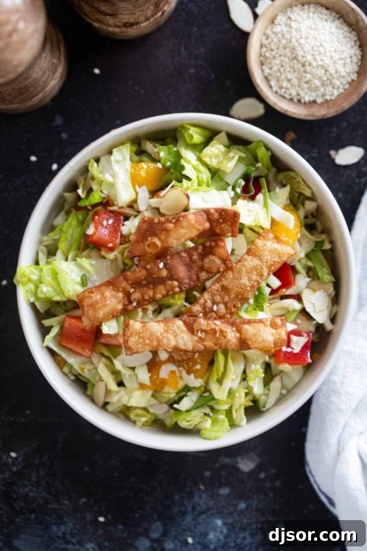 Vibrant Asian Crunch Salad 8 Bowl filled with Asian Chopped Salad topped with fried wonton strips.
