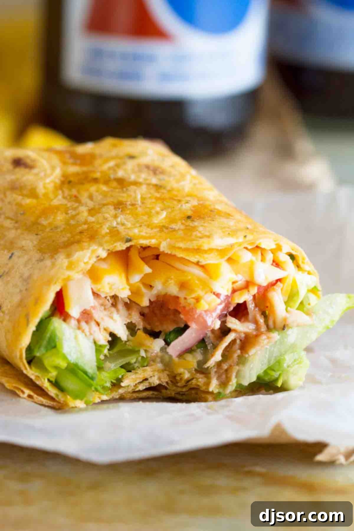 bbq chicken wrap with a bite taken from it.