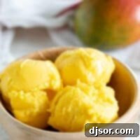 Tropical Mango Delight 2 Wooden bowl with three scoops of Mango Sorbet