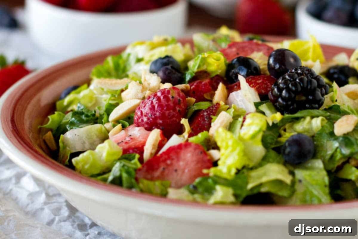 Fresh berries and sugared almonds are the stars of this delightful Summer Chopped Salad, complemented by a homemade poppy seed dressing. A refreshing Summer Chopped Salad overflowing with colorful fresh berries and crunchy sugared almonds, perfect for a light summer meal.
