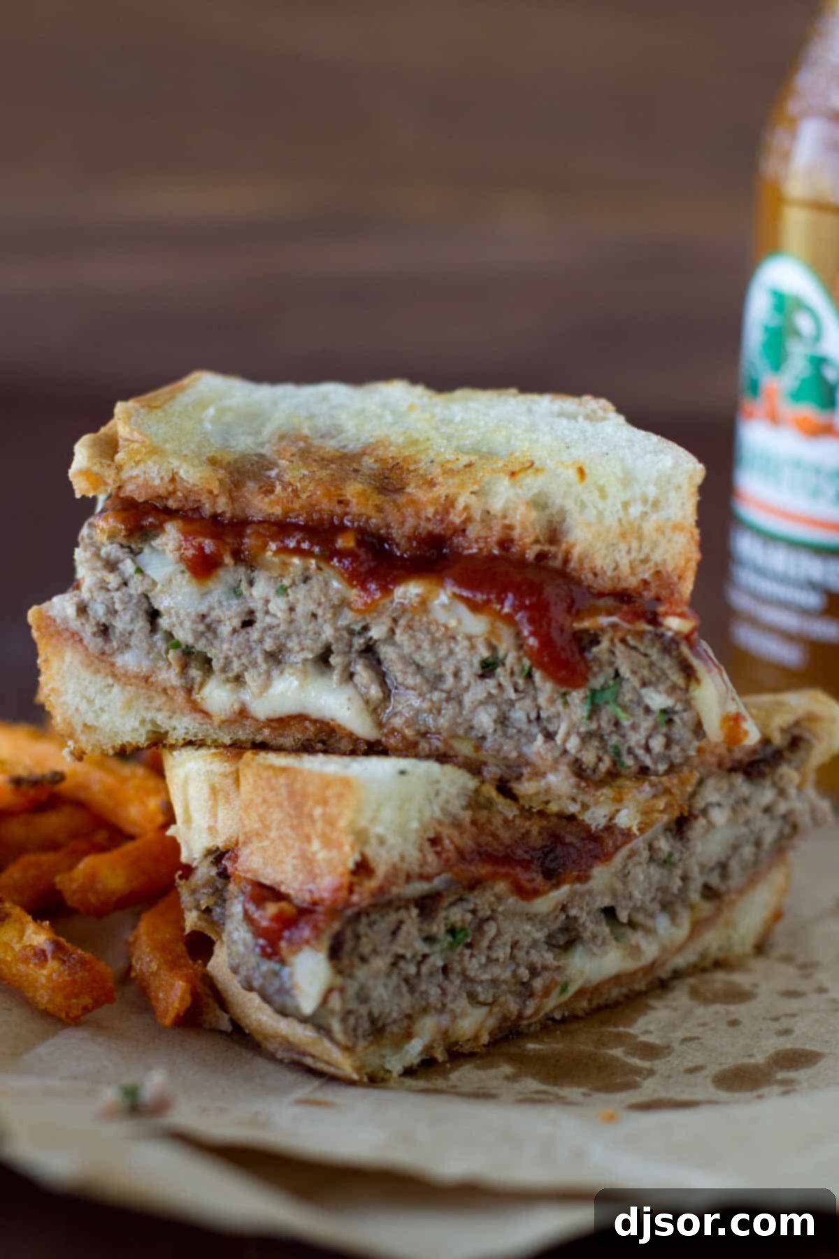 Italian Burger cut in half to show the inside layers of patty, cheese, and sauce.