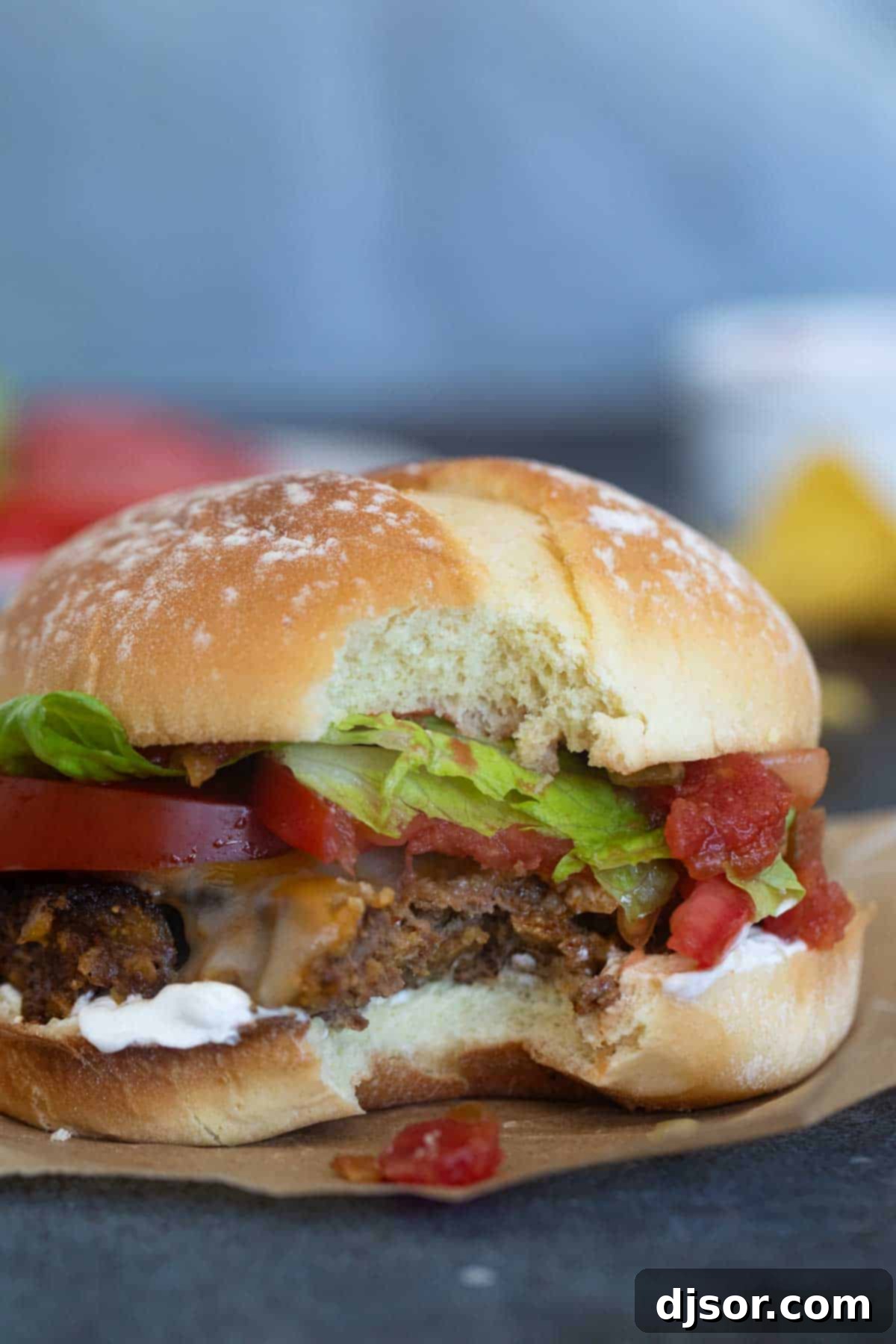 Fiesta Burgers 8 Taco burger with a bite taken from it.