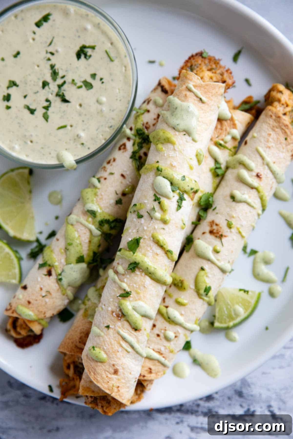 Crispy Chicken Flautas 8 Chicken Flautas on a plate with a bowl of cilantro ranch dipping sauce.