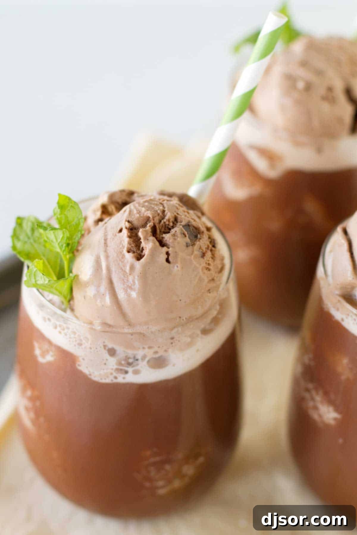 Iced Chocolate topped with gelato and mint - a refreshing summer treat Close-up top view of an Iced Chocolate drink, adorned with a scoop of chocolate gelato and a fresh mint sprig
