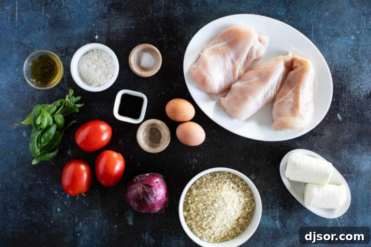 A vibrant selection of fresh ingredients laid out on a wooden surface, including ripe tomatoes, green basil leaves, red onion, a bottle of olive oil, and a meat mallet, all ready for making Bruschetta Chicken.