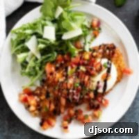 Bruschetta Chicken on a plate drizzled with balsamic vinegar.