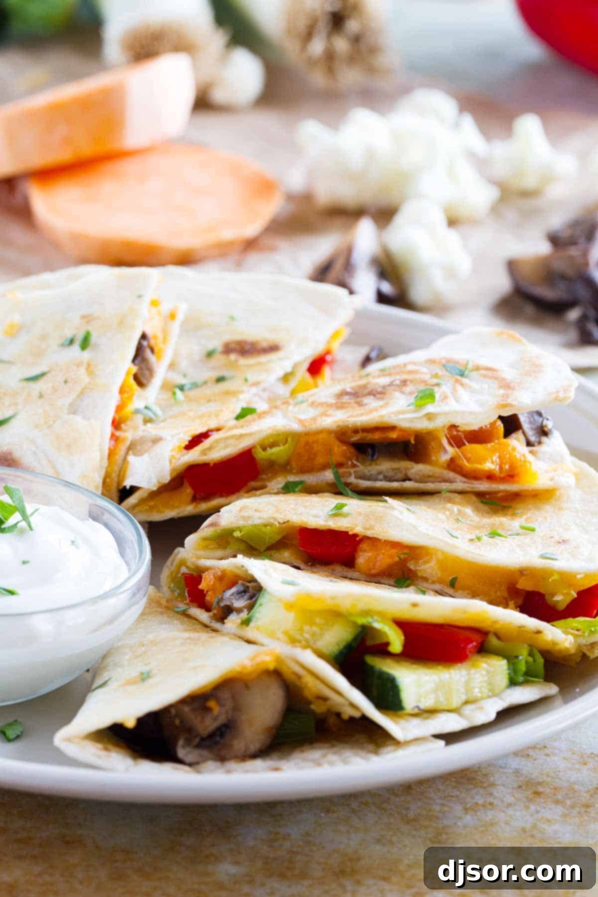 Slices of a veggie quesadilla fanned out on a plate.