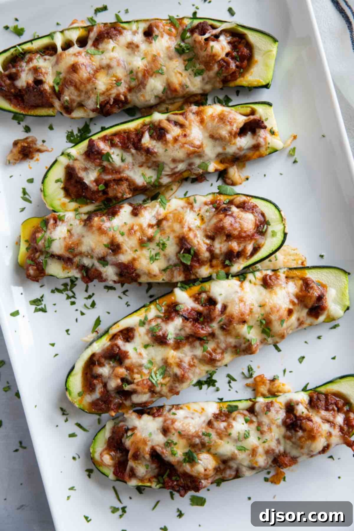 Stuffed Zucchini Boats on a platter topped with parsley.