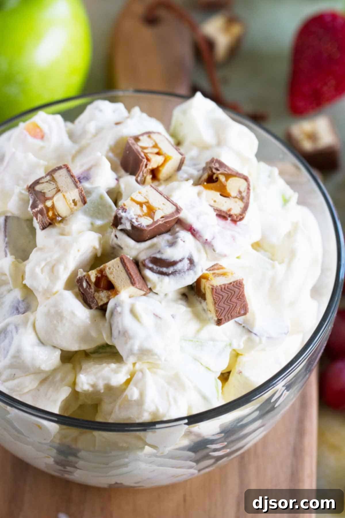Snickers Salad - a delightful sweet salad with crisp apples, juicy grapes, and chopped Snickers candy bars mixed in a creamy vanilla pudding base. A perfect dessert or unique side dish.