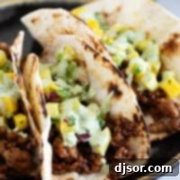 Island Taco Fiesta 9 Plate with 3 Hawaiian Tacos topped with pineapple mango salsa and cilantro lime sauce.