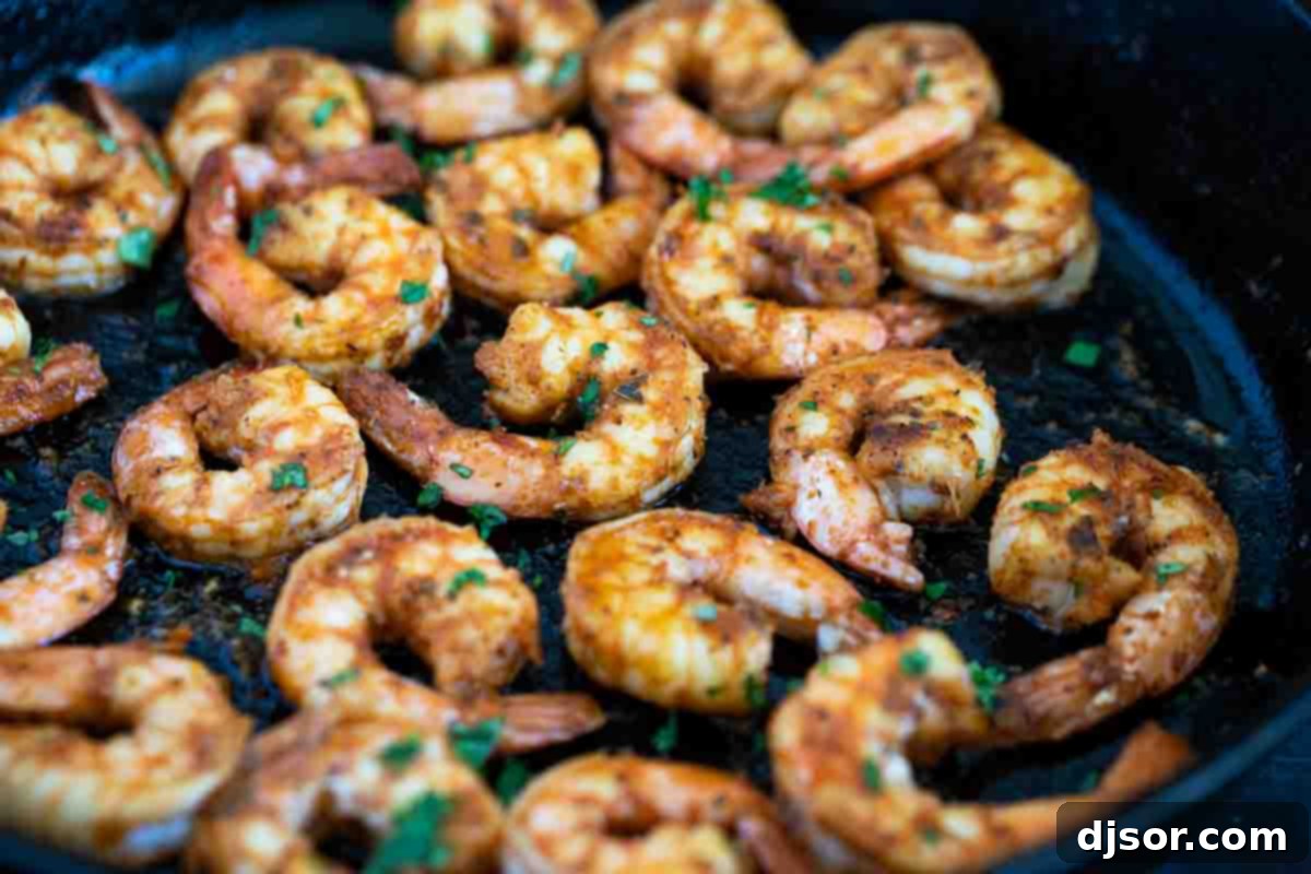 Shrimp with Cajun seasoning cooked in a cast iron skillet. This Cajun Shrimp just may be the easiest recipe ever! All it takes is about 10 minutes for this easy shrimp recipe. Serve the shrimp over grits, pasta, or by themselves for a spicy, flavorful dish.