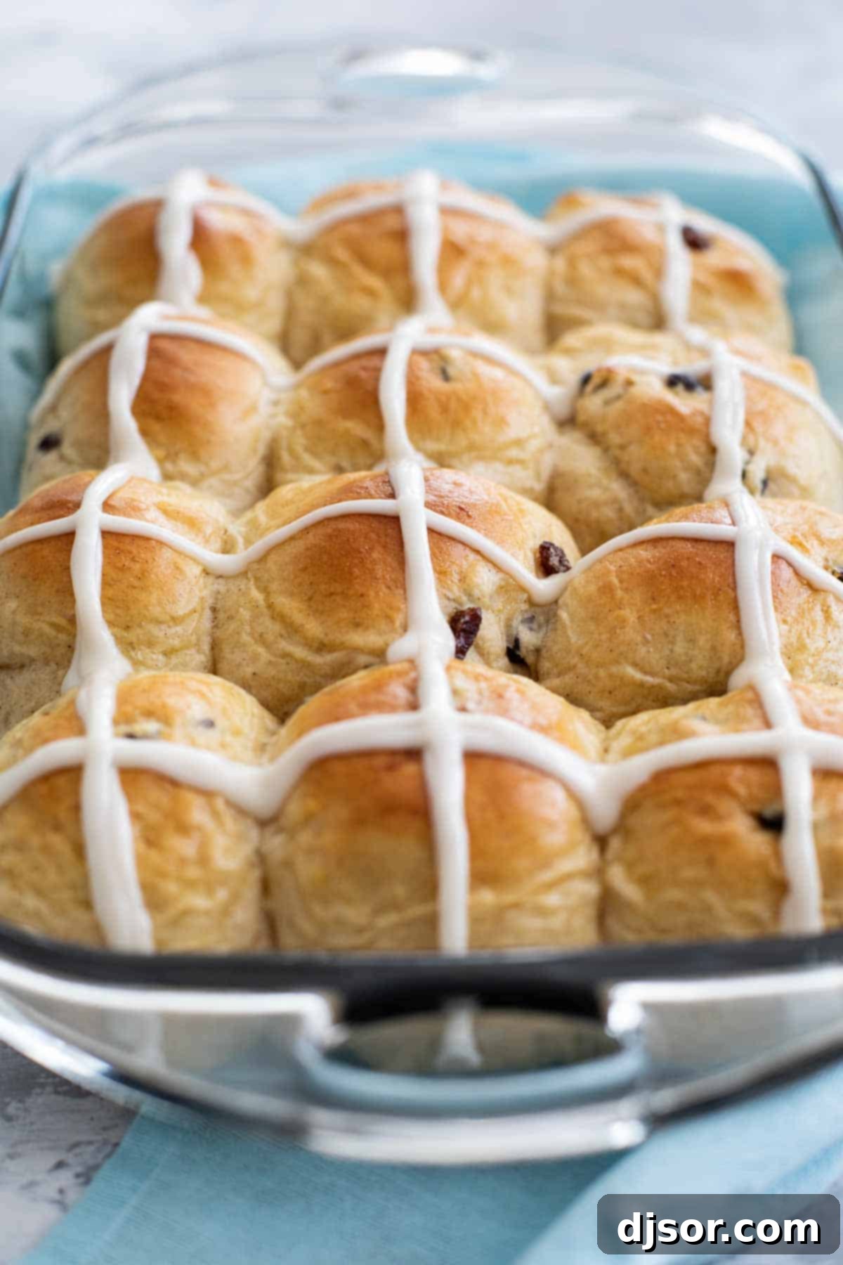 Traditional Hot Cross Buns for Easter Celebrations A tray of freshly baked Hot Cross Buns with white icing crosses, ready for serving.