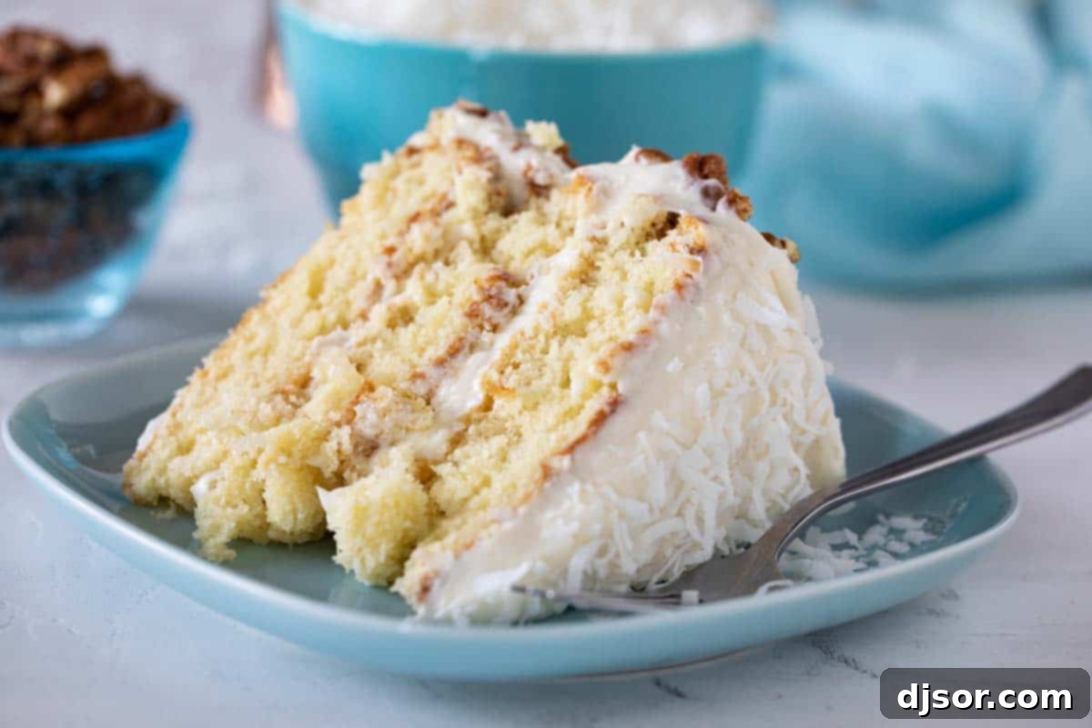A perfect slice of Italian Cream Cake, layered with creamy frosting and topped with pecans and coconut. slice of Italian Cream Cake on a plate with a fork, showcasing layers