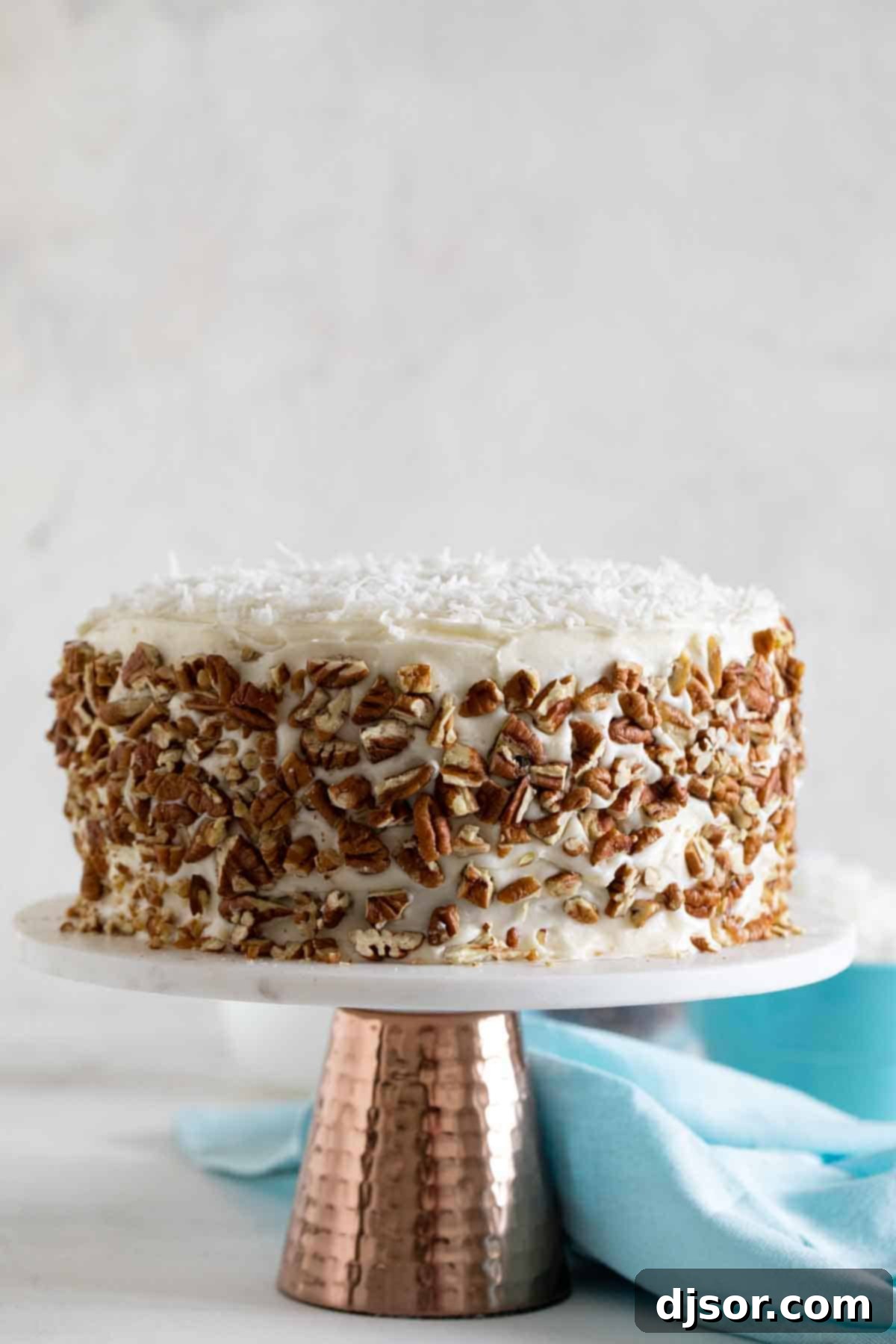 The finished Italian Cream Cake, a true centerpiece dessert. Full Italian Cream Cake displayed on a beautiful cake stand