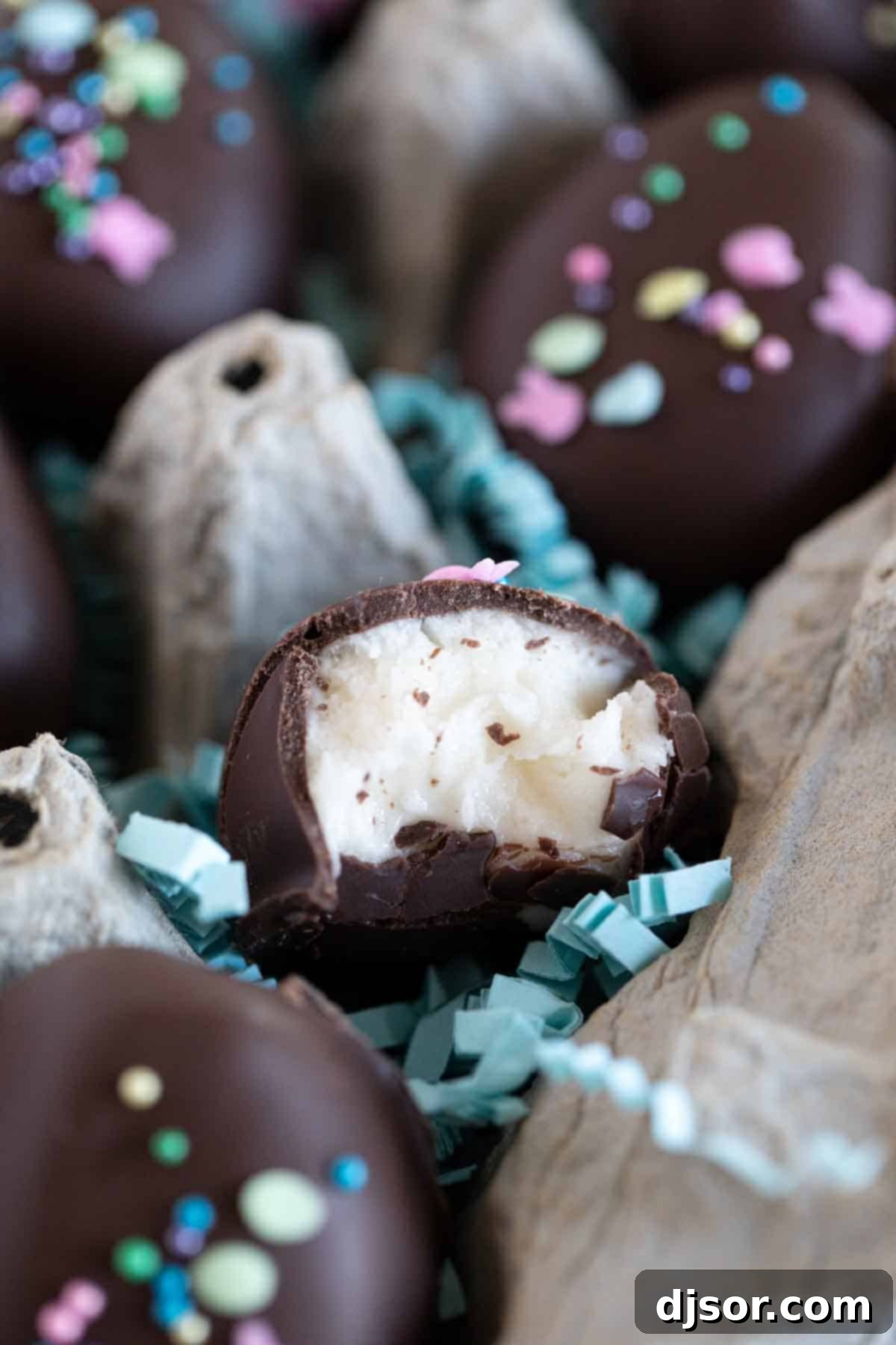 The Irresistible Interior of a Marshmallow Truffle A close-up shot of an Easter Egg Marshmallow Creme Truffle, bitten into to reveal its creamy, soft marshmallow interior contrasting beautifully with the rich chocolate coating, and adorned with delicate sprinkles.