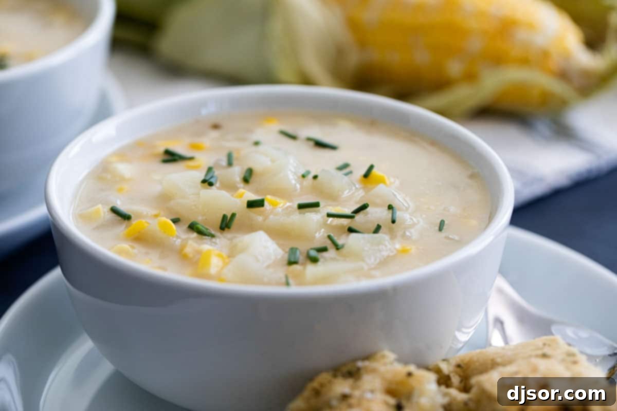 Creamy Potato Corn Chowder with Fresh Corn Bowl of Potato Corn Chowder with corn in the background, garnished with fresh herbs