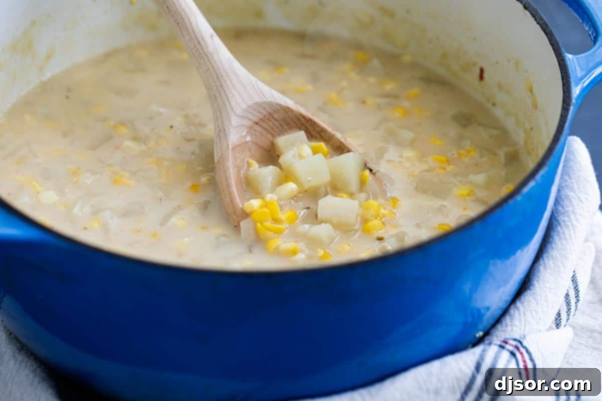 Preparing Potato Corn Chowder in a Dutch Oven chowder made with potatoes and corn in a dutch oven, being stirred
