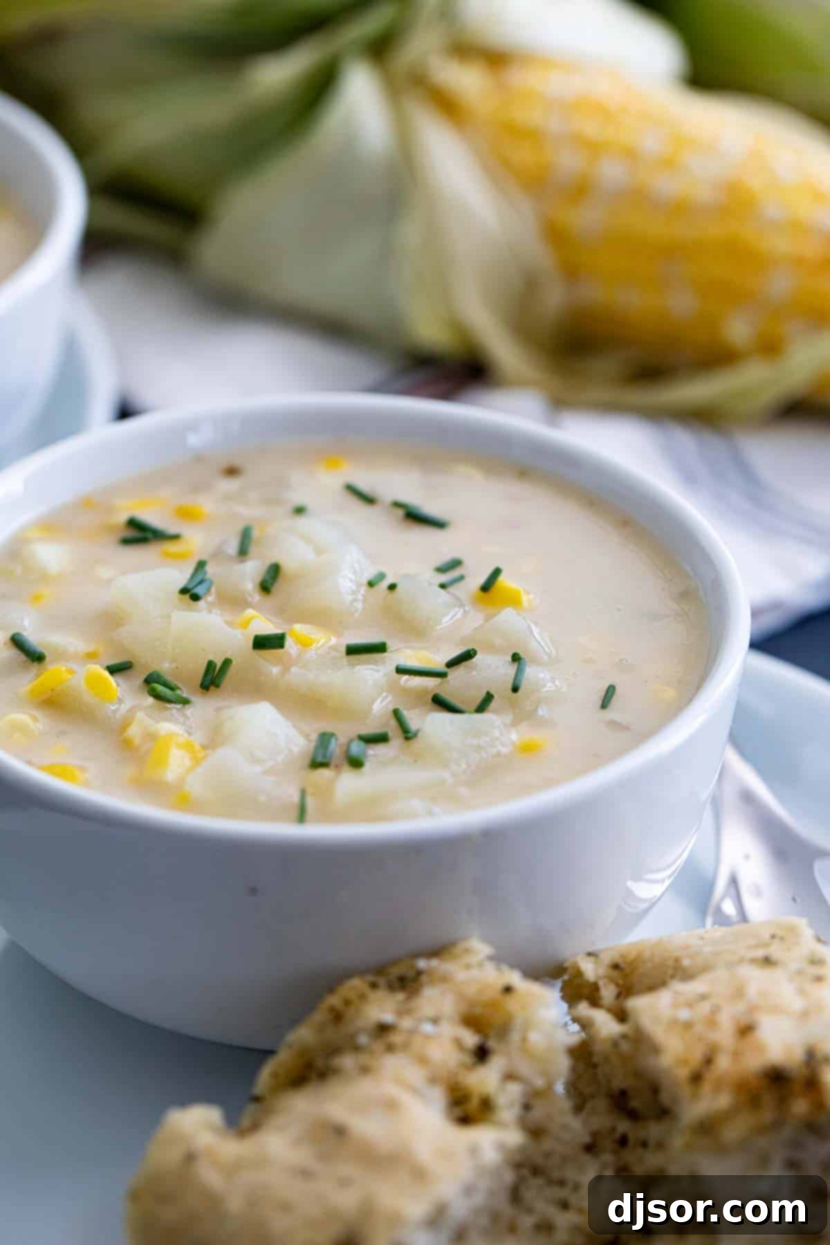 Garnished Potato Corn Chowder Ready to Serve Close-up of potato corn chowder topped with fresh chives in a bowl
