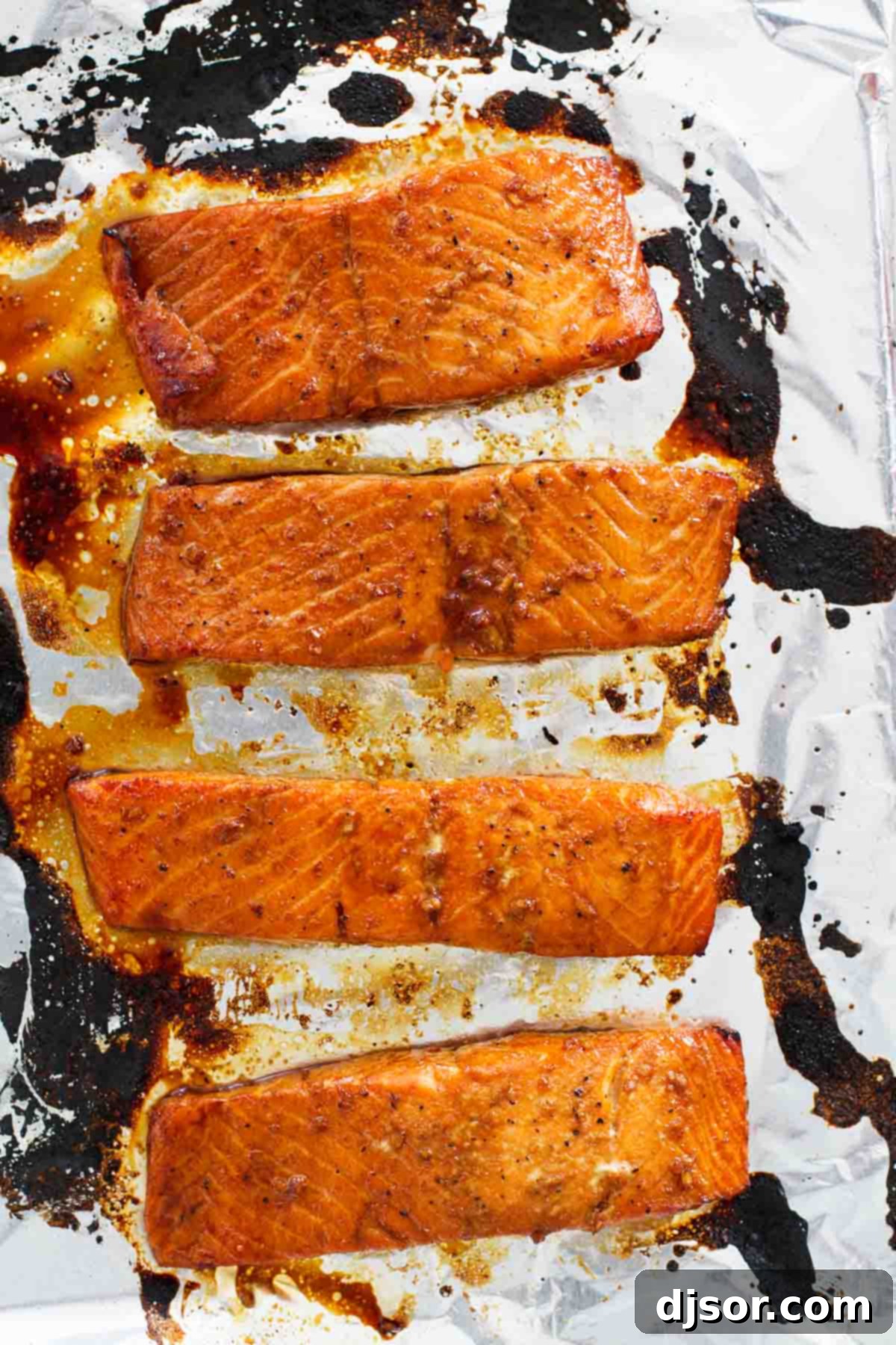 Ginger Soy Glazed Salmon 3 Soy Ginger Salmon broiled on a foil lined baking sheet.