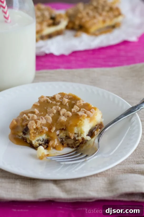 A delectable Caramel Cookie Cheesecake Bar with a bite taken from it, revealing its layers.