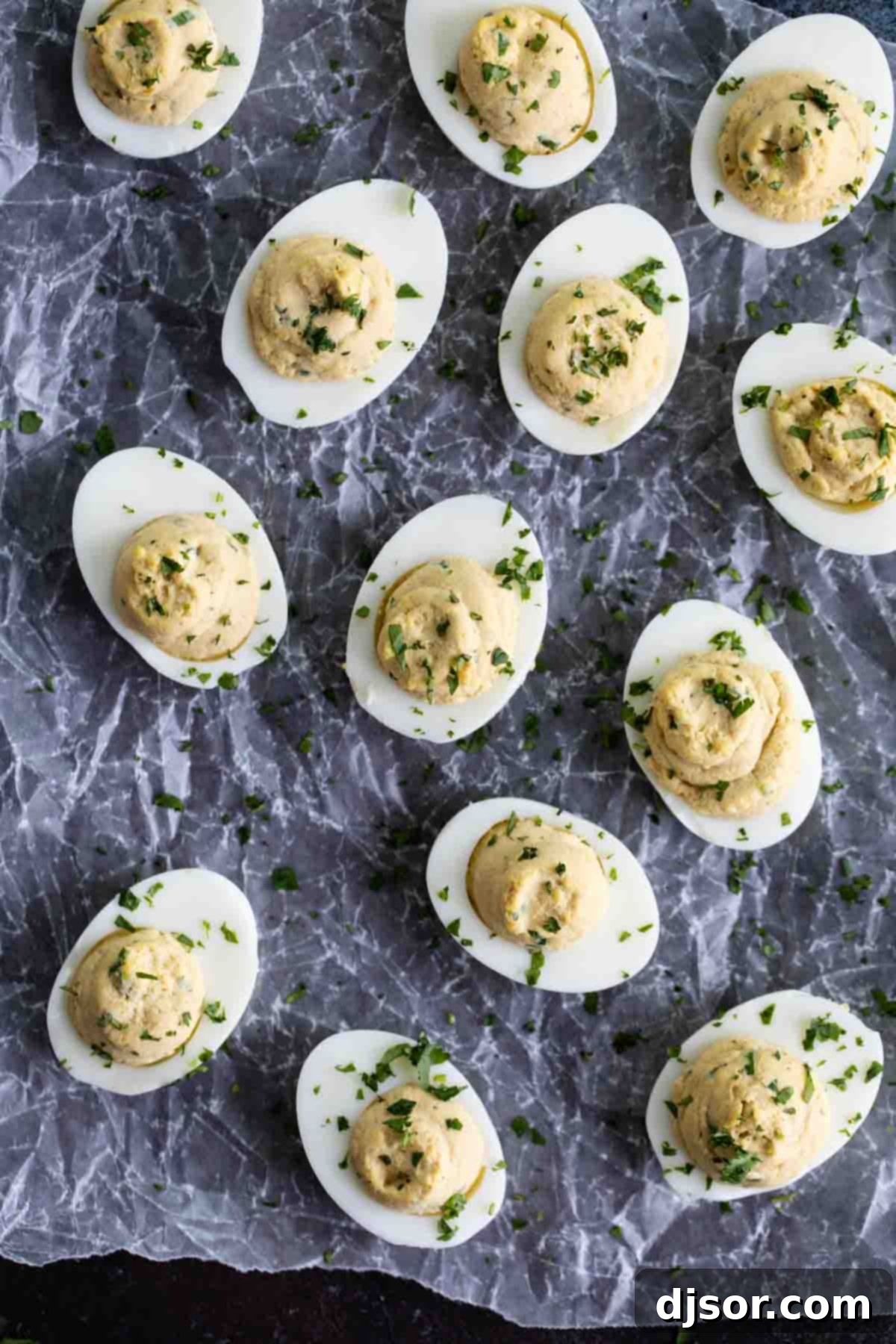 Gourmet Asian Deviled Eggs, an exotic and flavorful appetizer. Asian deviled eggs meticulously topped with fresh, chopped cilantro, ready to be served.