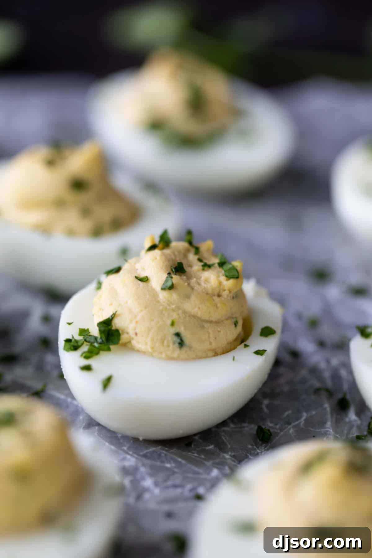 Freshly prepared Asian Inspired Deviled Eggs, a vibrant and savory appetizer. Exquisite Asian Inspired Deviled Eggs, delicately topped with finely minced cilantro for a gourmet touch.