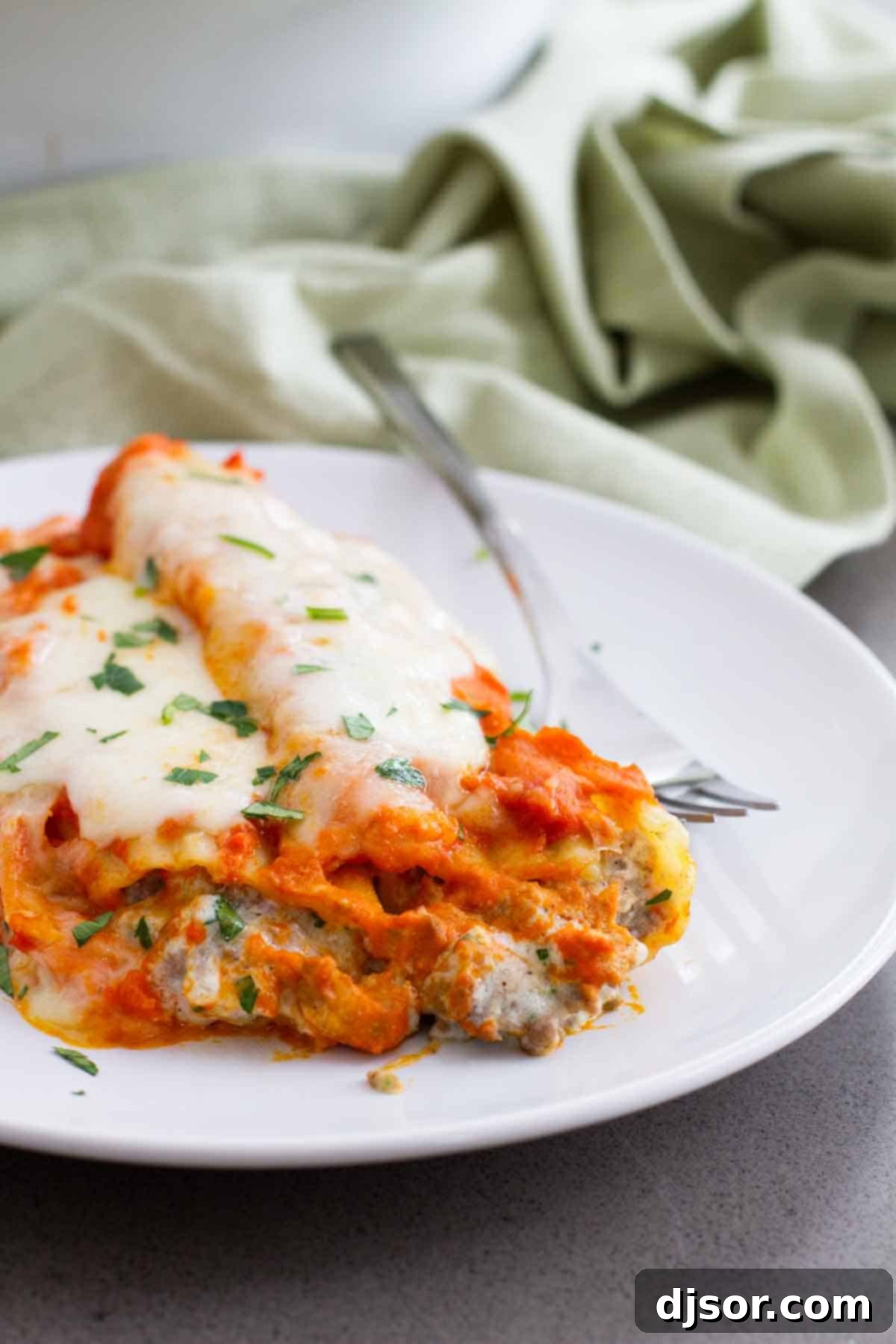 Ground Beef Stuffed Manicotti on a plate, showing the rich sauce and melted cheese