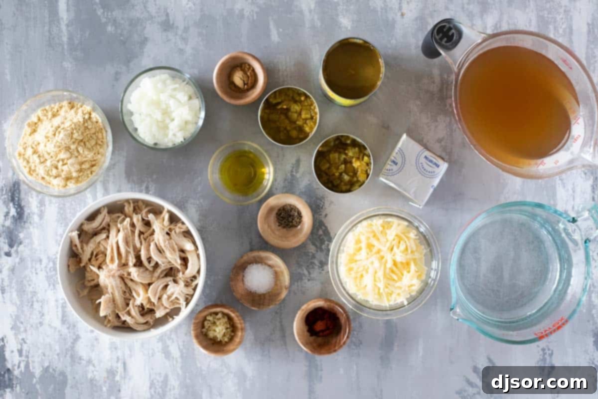 Zesty Verde Chicken Enchilada Soup 3 A collection of fresh and canned ingredients neatly arranged on a wooden surface, ready for making Green Chicken Enchilada Soup.