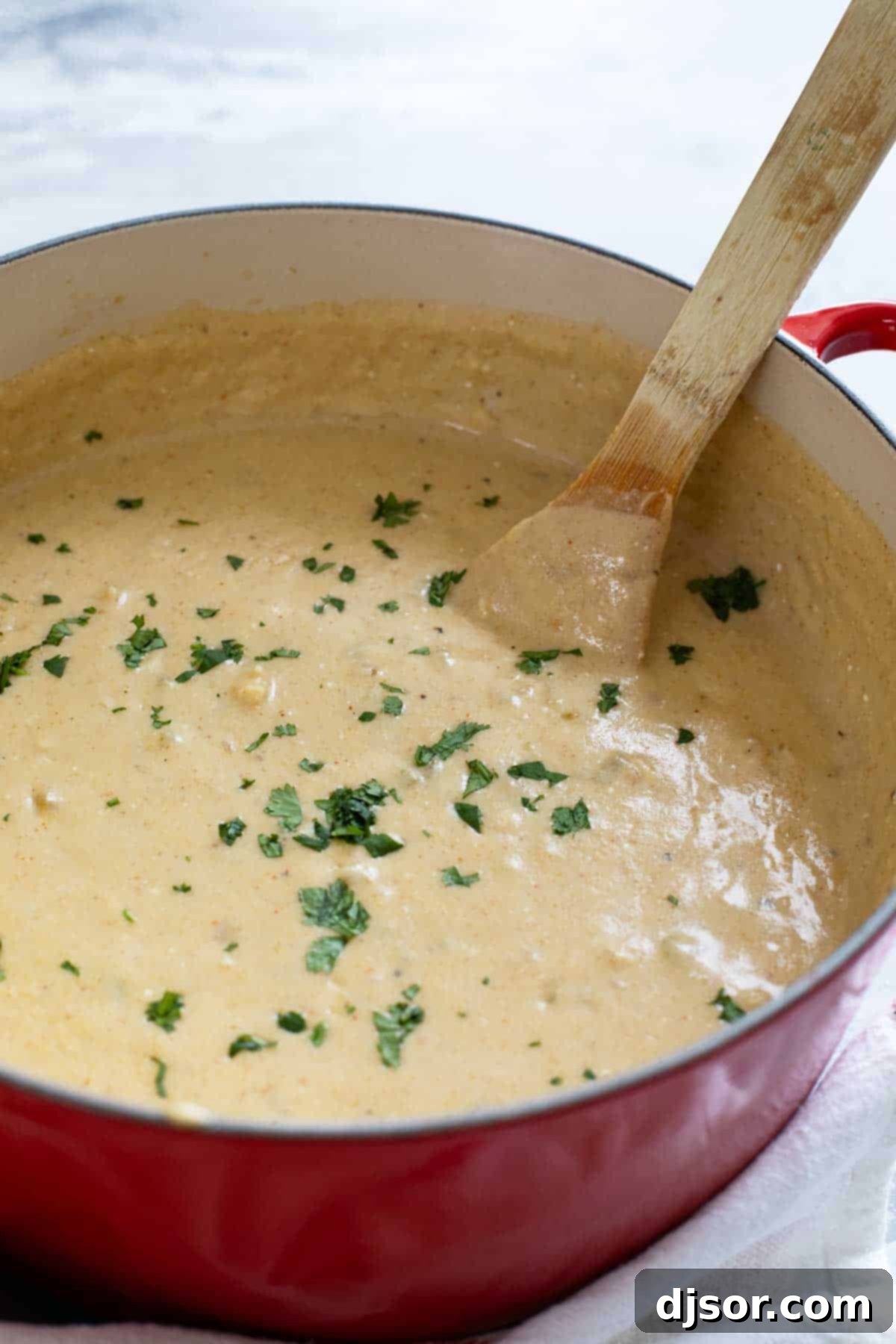 Zesty Verde Chicken Enchilada Soup 7 A large pot filled with rich, green chicken enchilada soup, steaming gently and ready to be served, highlighting its comforting appeal.