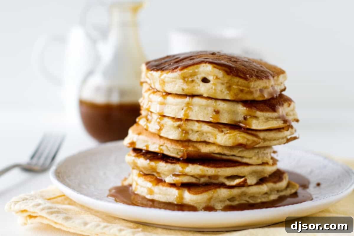 Golden Caramel Apple Pancakes 2 Stack of Apple Pancakes with Caramel Apple Syrup being poured on top