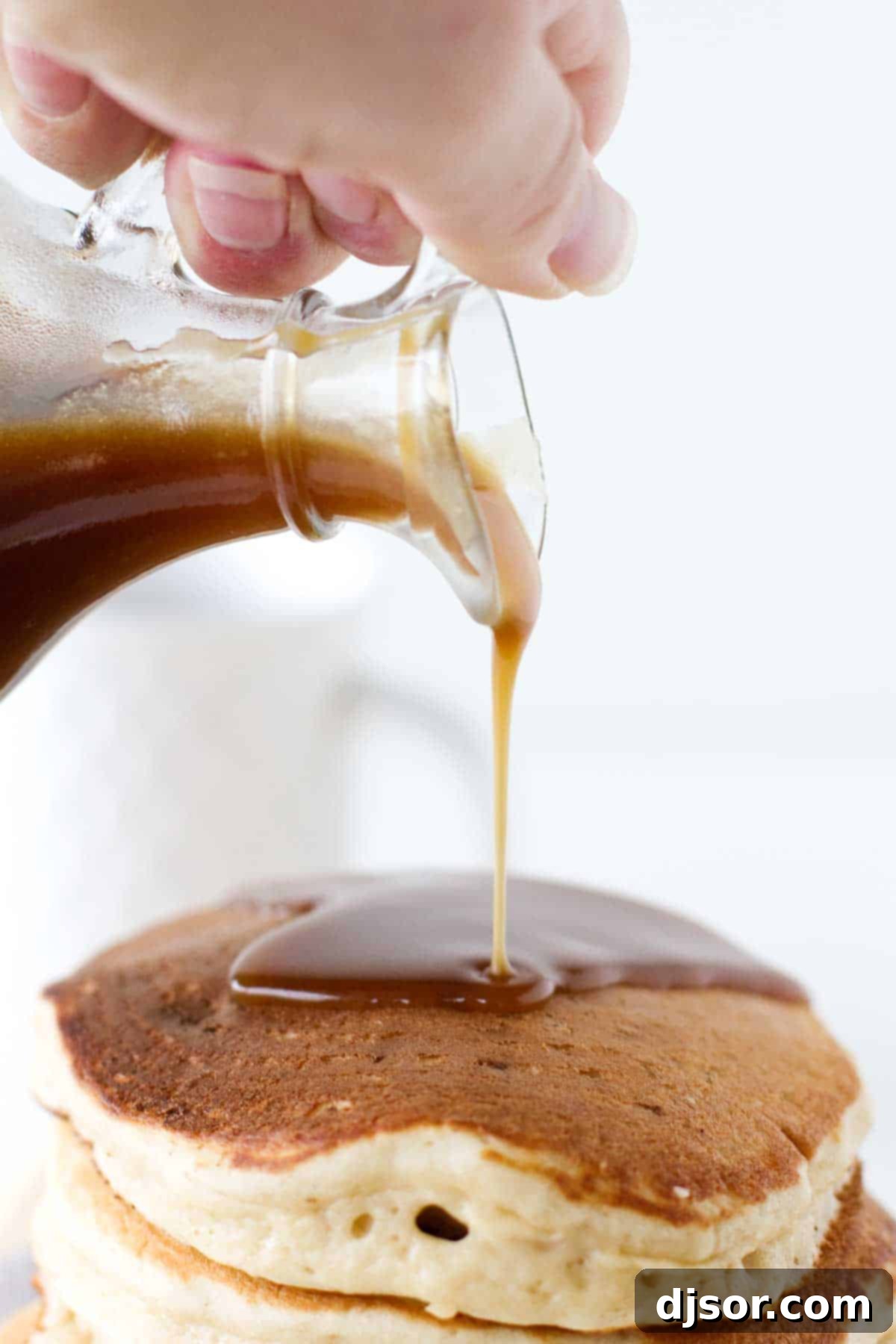 Golden Caramel Apple Pancakes 3 Caramel Apple Syrup being poured on a stack of Apple Pancakes