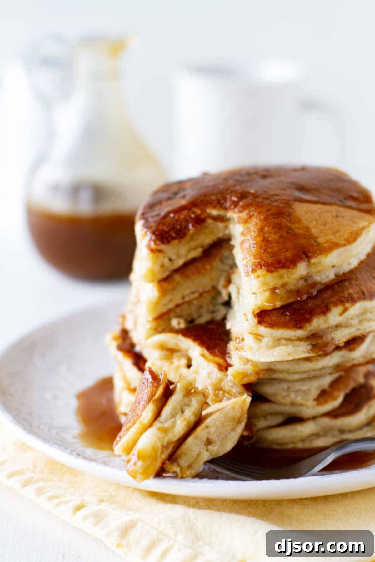 Golden Caramel Apple Pancakes 4 A bite of Apple Pancakes with Caramel Apple Syrup on a fork