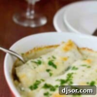 Hearty Chicken and Mushroom Manicotti Bake 2 Baking dish with Chicken Manicotti with Mushrooms topped with parsley.