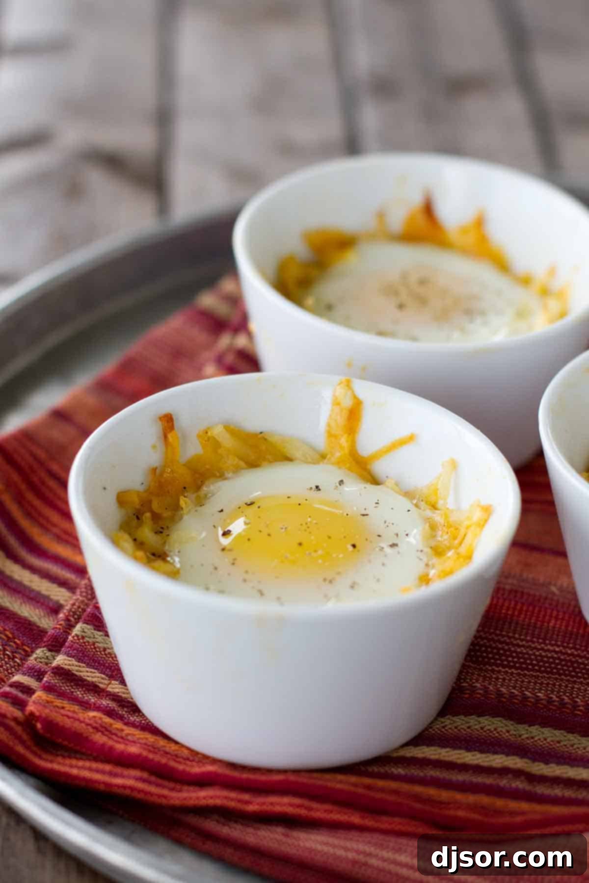 Mexican Style Eggs in a Nest: Hash browns, cheese, taco seasoning and eggs for an easy, entertaining breakfast Individual ramekins with Mexican Style Eggs in a Nest