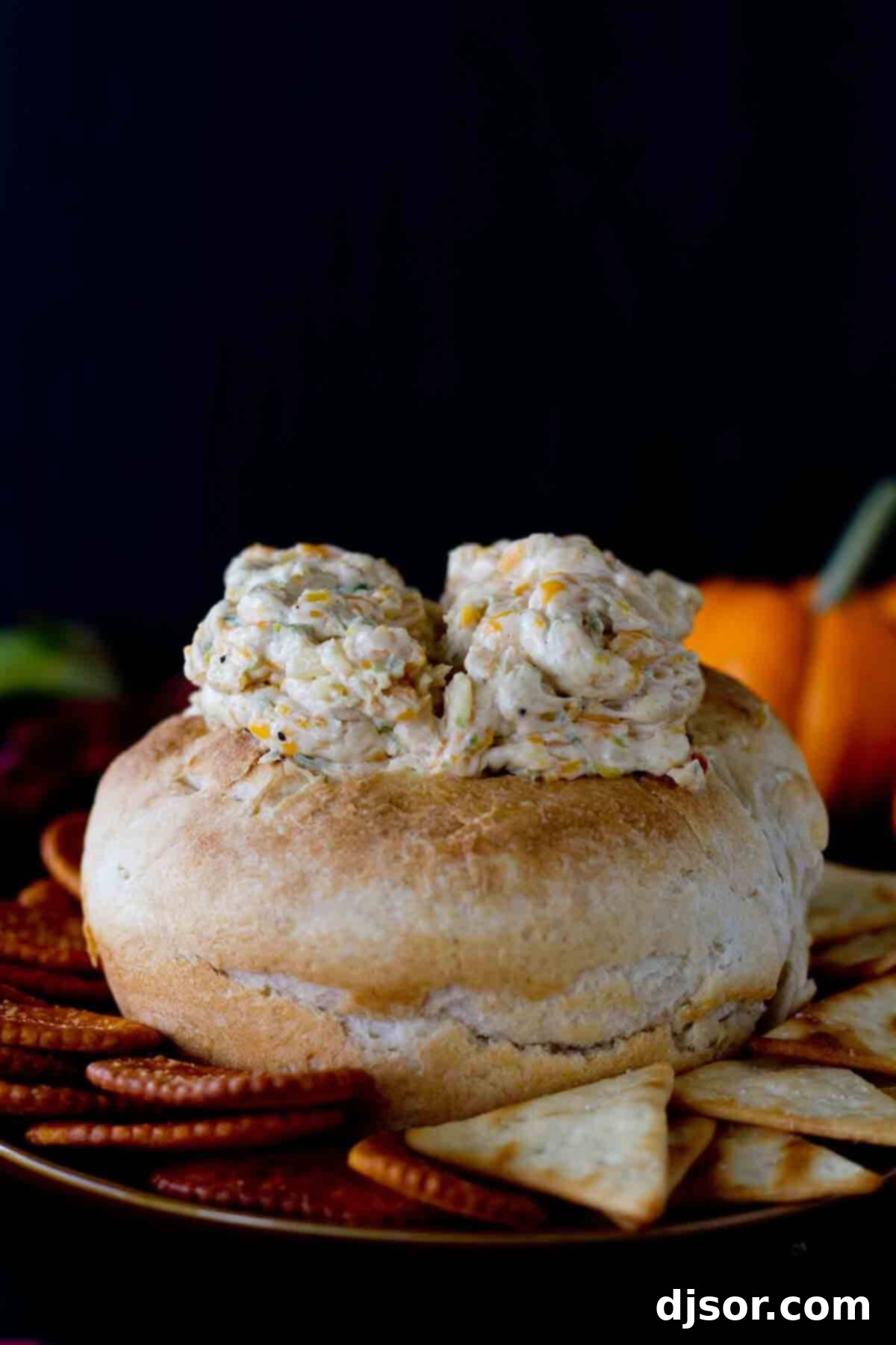 Monster Brains - a creamy, savory cheese dip artfully presented in a bread bowl to resemble a brain, ideal for Halloween parties.