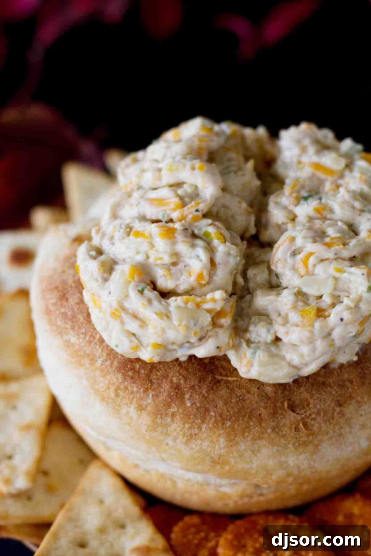 Close-up of the Monster Brains cheese dip served in a bread bowl, highlighting the intricate brain-like piping and delicious texture.