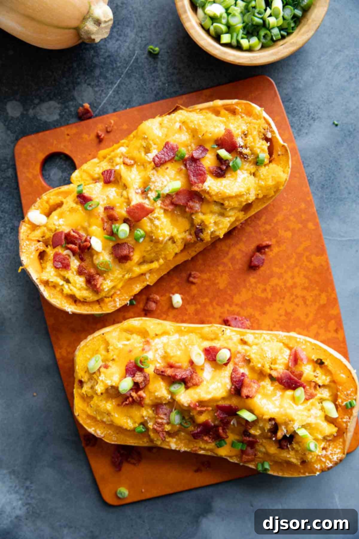 Savory Stuffed Butternut Squash Delight 5 Two butternut squash halves filled with butternut squash, cheese, and bacon.